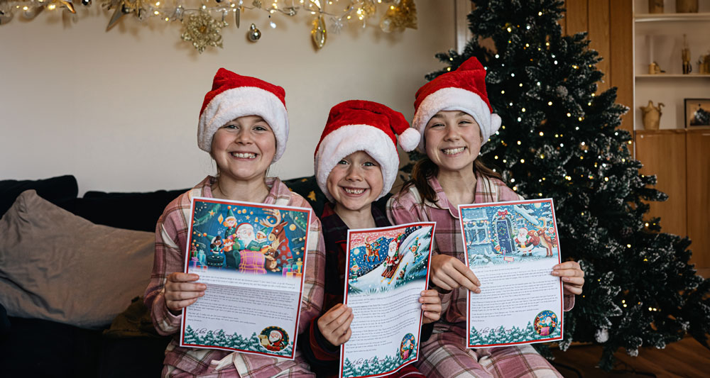 Children holding their personalised letters from Santa